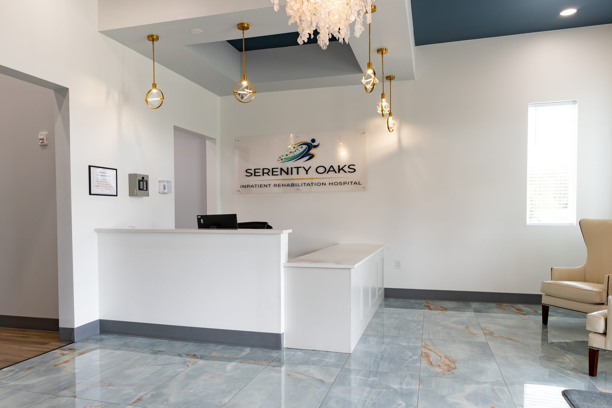 The reception desk in the main entry at Serenity Oaks Inpatient Rehabilitation Hospital